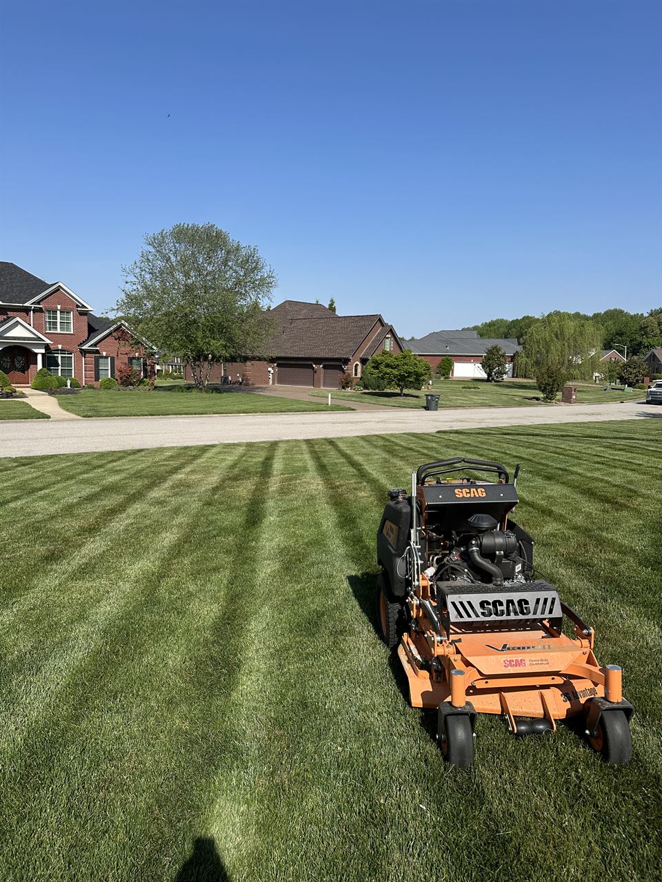 A Horizon Outdoor Solutions commercial mower on a freshly cut, striped lawn at an Owensboro, KY home